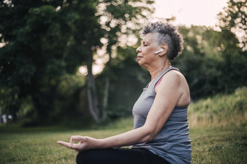 Woman sitting outdoors meditating