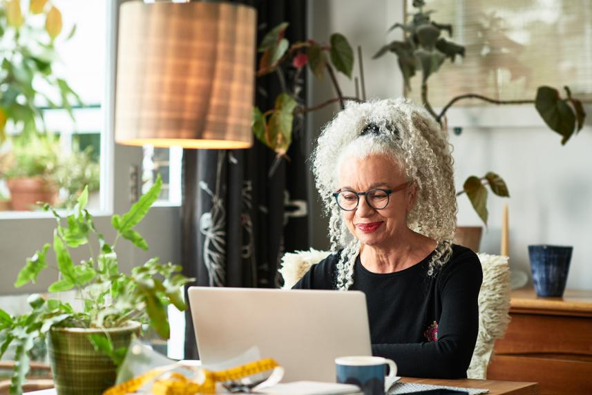 Woman sitting at desk working on laptop