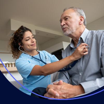 A nurse checking her patient's heart rate in his own bedroom, at home